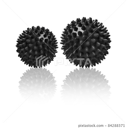 Two black spiny massage balls isolated on white. Concept of physiotherapy or fitness. Closeup of a colorful rubber ball for dog teeth on a white color background. Corona virus model. Snowflake. 84288371