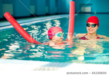 Child in a swimming pool Child in a swimming pool 84288600