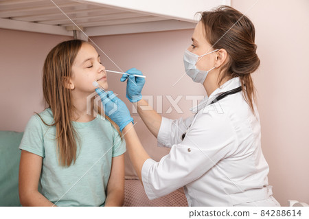 Pediatrician taking nasal test sample from child at home during lockdown Pediatrician taking nasal test sample from child at home during lockdown 84288614
