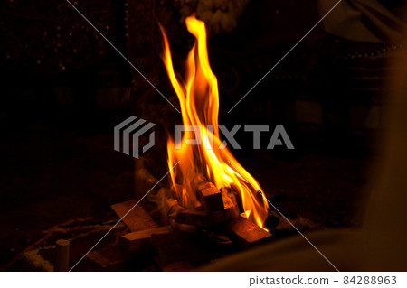 Beautiful view of the flames of the campfire in the darkness for havan pooja Beautiful view of the flames of the campfire in the darkness for havan pooja 84288963