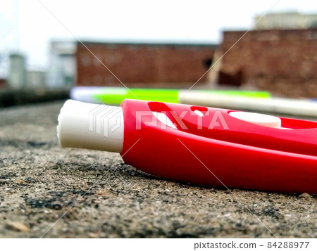 Selective focus shot of a red pen on a wall Selective focus shot of a red pen on a wall 84288977