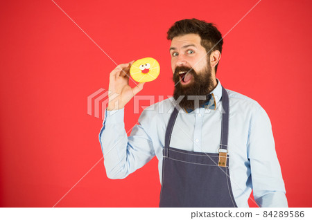 Bearded man in apron. Diet and healthy food. Donut diet. 84289586