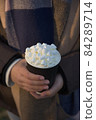 Vertical image of youthful female hands holding hot chocolate to go 84289714