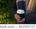 Takeaway hot beverage to go, in a disposable yet recyclable paper cup 84289722