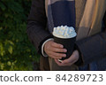 Warm evening sun highlights marshmallows atop of hot takeaway cacao 84289723