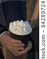Hot take away beverage with an abundance of marshmallows and cream 84289724