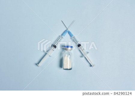 Anti vaccination or vaccine skepticism concept. Syringes crossed on bright blue background. Healthcare medicine. Covid-19 vaccine immunization refusing 84290124