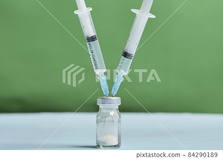 A covid-19 vaccine vial with syringes. Covid-19 vaccine booster dose. Booster shot of new coronavirus vaccine injection 84290189