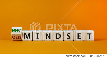 New vs old mindset symbol. Turned the wooden cube and changed words 'old mindset' to 'new mindset'. Beautiful orange background. Business, new or old mindset concept. Copy space. New vs old mindset symbol. Turned the wooden cube and changed words 'old mindset' to 'new mindset'. Beautiful orange background. Business, new or old mindset concept. Copy space. 84290244