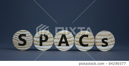 SPACs symbol. Wooden circles with words 'SPACs, special purpose acquisition companies' on beautiful grey background, copy space. Business and SPACs concept. 84290377