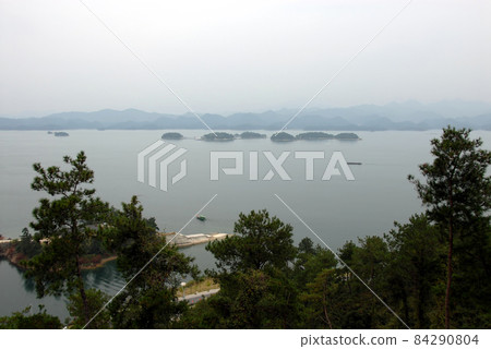 Qiandao Hu, Zhejiang Province, China: View of the lake and islands with foreground forest. Qiandao Hu translates as Thousand Island Lake and is a reservoir near Hangzhou. 84290804