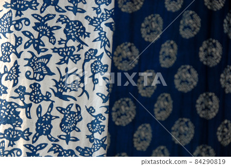 Wuzhen Water Town, Zhejiang Province, China. Indigo blue and white printed calico - a traditional cotton fabric produced in Wuzhen and a souvenir purchase for tourists. 84290819