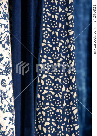 Wuzhen Water Town, Zhejiang Province, China. Indigo blue and white printed calico - a traditional cotton fabric produced in Wuzhen and a souvenir purchase for tourists. 84290821