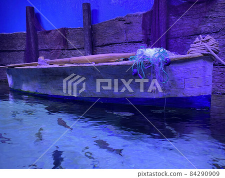 Wood Skiff Tied At Dock with Flemish Coil Beside Cleat Wood Skiff Tied At Dock with Flemish Coil Beside Cleat 84290909