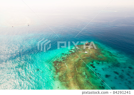 Shallow waters of Persian Gulf. Red warning beacon tower Shallow waters of Persian Gulf. Red warning beacon tower 84291241