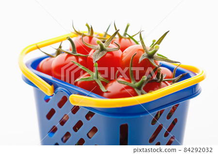 cherry tomatoes in a shopping basket, white background cherry tomatoes in a shopping basket, white background 84292032