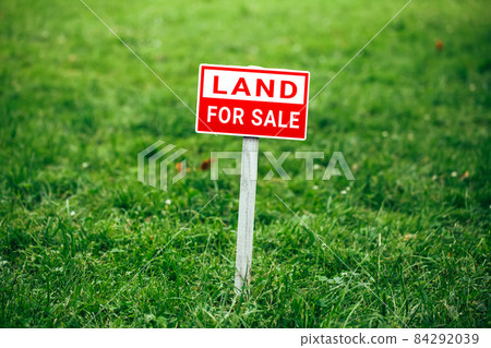 land for sale plate sign, green grass background land for sale plate sign, green grass background 84292039