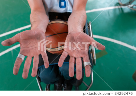 the hands of disabled basketball players after an exhausting game in the arena. Selective focus the hands of disabled basketball players after an exhausting game in the arena. Selective focus 84292476