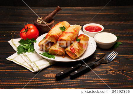 Portion of stuffed cabbage rolls on wooden table Portion of stuffed cabbage rolls on wooden table 84292596