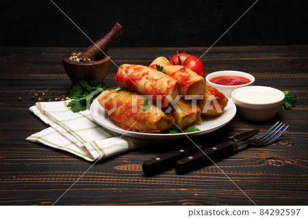 Portion of stuffed cabbage rolls on wooden table Portion of stuffed cabbage rolls on wooden table 84292597