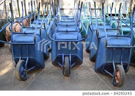Multiple wheelbarrows leaning against Multiple wheelbarrows leaning against 84293243