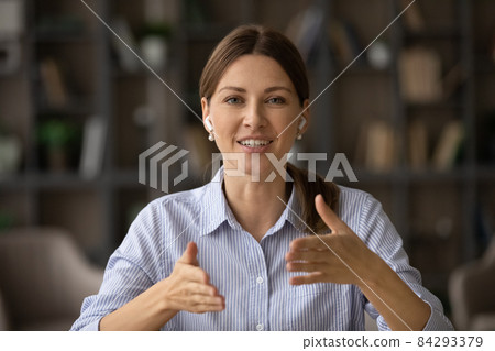 Female counsellor wear earphones provide support to client through videocall 84293379