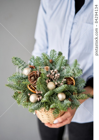 Christmas box with fir branches for the holiday. The new year celebration. European flower shop 84294134