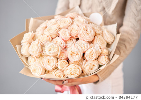 Floral carpet, flower texture, shop concept. Beautiful fresh blossoming flowers roses, spray roses. Blossom in vases and pails. Top view. 84294177