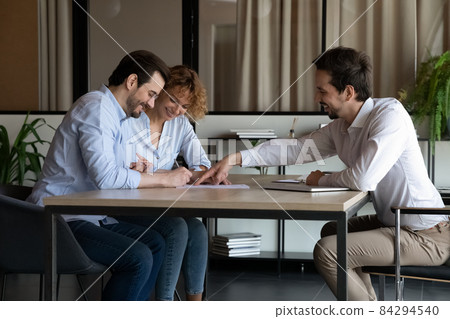 Smiling young specialist making agreement with clients. 84294540