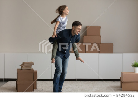 Excited father piggy backing daughter, rejoicing relocation in new home Excited father piggy backing daughter, rejoicing relocation in new home 84294552