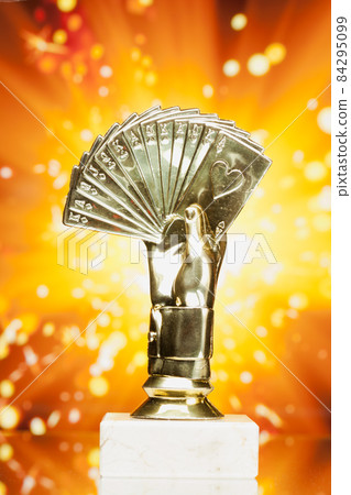 poker cards trophy against shiny sparks background poker cards trophy against shiny sparks background 84295099