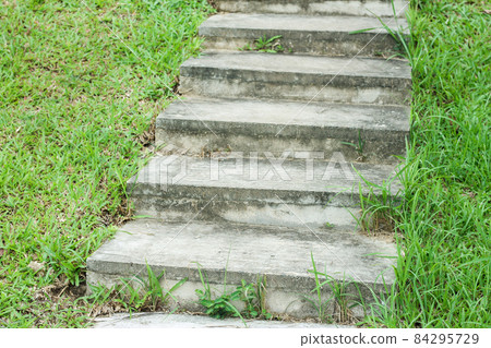 Stone steps in an area with abundant green grass during the rainy season. Stone steps in an area with abundant green grass during the rainy season. 84295729