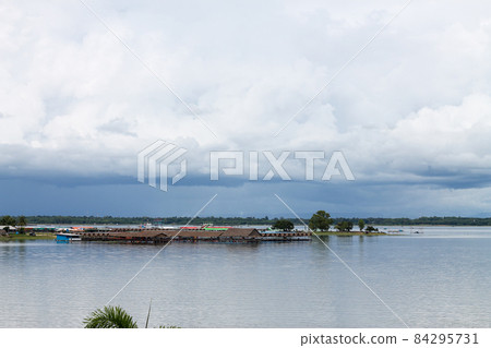 The beach and the water pavilion seen from far away. showing black rain clouds 84295731