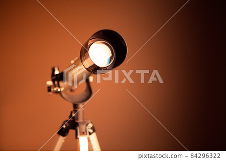 telescope on brown background with copy-space telescope on brown background with copy-space 84296322