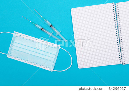 Vaccination or Revaccination Concept - Three Insulin Syringe on Blue Table 84296917