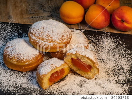 Freshly cooked Apricot jam doughnuts, referred to as jelly doughnuts, donuts in the US Freshly cooked Apricot jam doughnuts, referred to as jelly doughnuts, donuts in the US 84303718