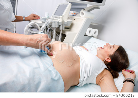 Joyful pregnant woman received good news doing obstetric ultrasonography Joyful pregnant woman received good news doing obstetric ultrasonography 84306212
