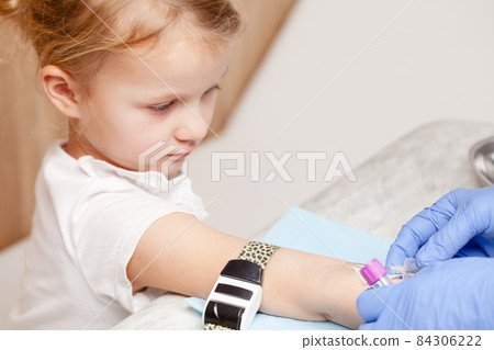 Nurse takes a blood sample from little girls arm - pediatric venipuncture procedure Nurse takes a blood sample from little girls arm - pediatric venipuncture procedure 84306222