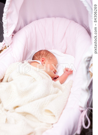 Newborn baby in a bassinet 84306269