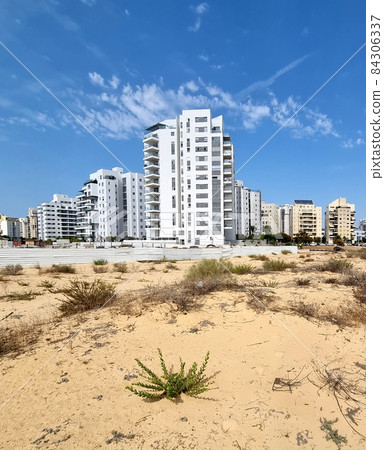 City construction among desert dunes. City construction among desert dunes. 84306337