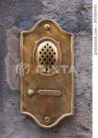 Old fashioned brass door bell intercom on wall in Lucca in Italy Old fashioned brass door bell intercom on wall in Lucca in Italy 84306445