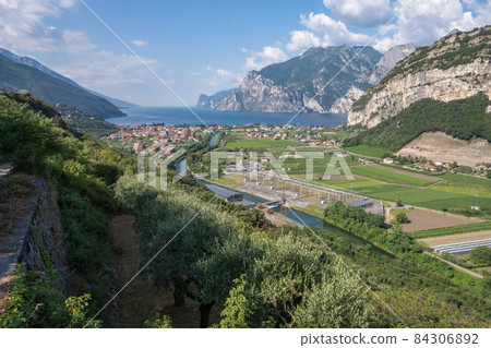 Sarca river springing from the Adamello-Presanella mountains in Italian Alps and flowing into Lake Garda at Nago-Torbole 84306892