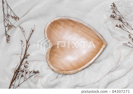 Wooden plate isolated above the tablecloth 84307271