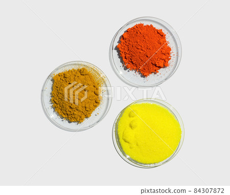 Lead (II,IV) oxide, Potassium Chromate and Organic Curcuma Powder in Chemical Watch Glass. Closeup chemical ingredient on white laboratory table. Top View 84307872