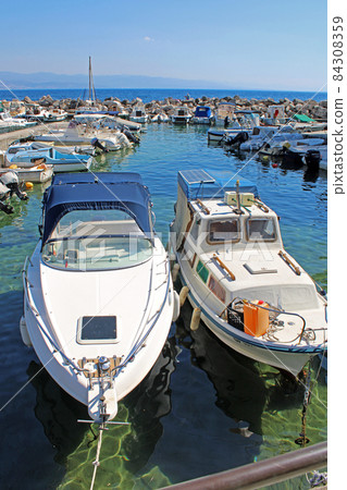 View from Icici's seaside promenade, harbor, Adriatic coast, Kvarner bay, city details, Croatia 84308359
