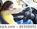 Young woman sneezing in the car 84308492