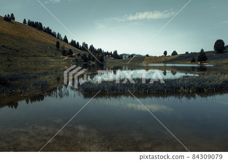 Lake of the Confins and Mountain landscape at sunrise. La Clusaz, France 84309079