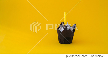Delicious chocolate cupcake with cream and candle on dark background. Chocolate muffin. Birthday cake party. Delicious chocolate cupcake with cream and candle on dark background. Chocolate muffin. Birthday cake party. 84309576