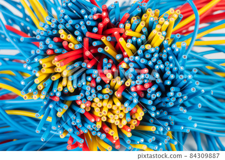 Group of colored electric cables closeup 84309887