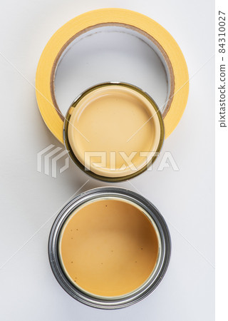 Opened paint can and painters tape top view Opened paint can and painters tape top view 84310027